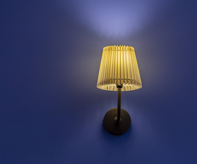 Glowing wall lamp on blue wall
