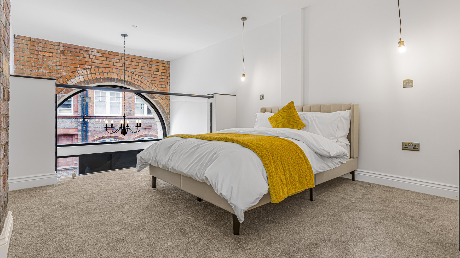 Bedroom with arched window double bed