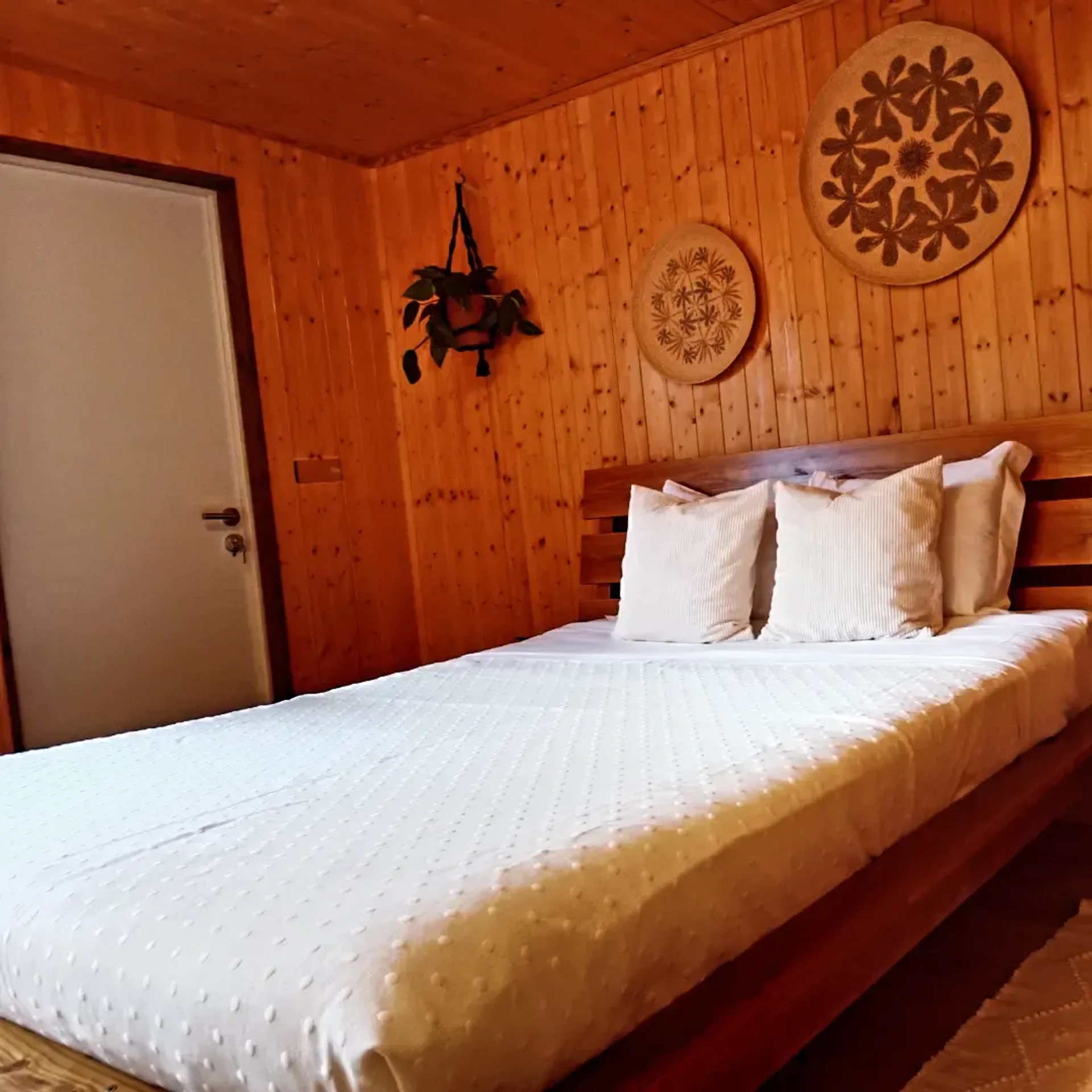 Wood-paneled bedroom with bed