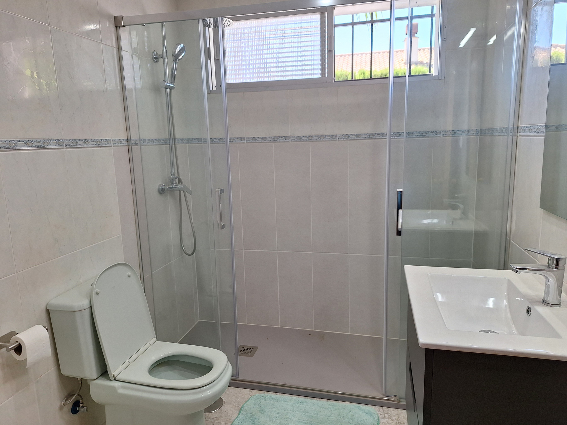 Bathroom with shower, toilet, sink