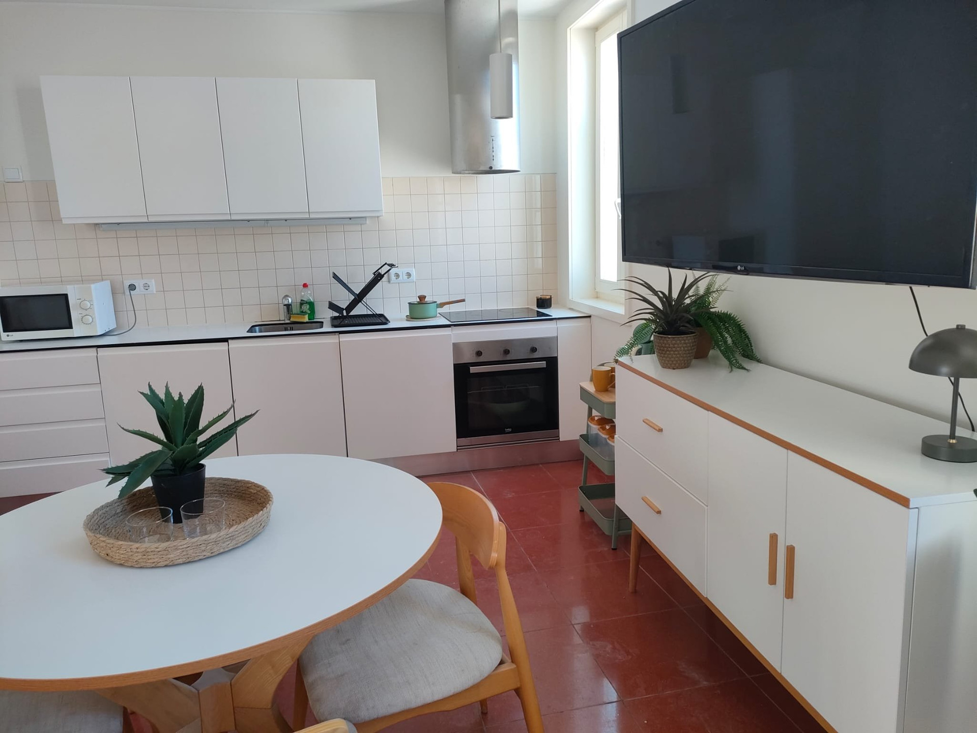 Kitchen dining area with large TV