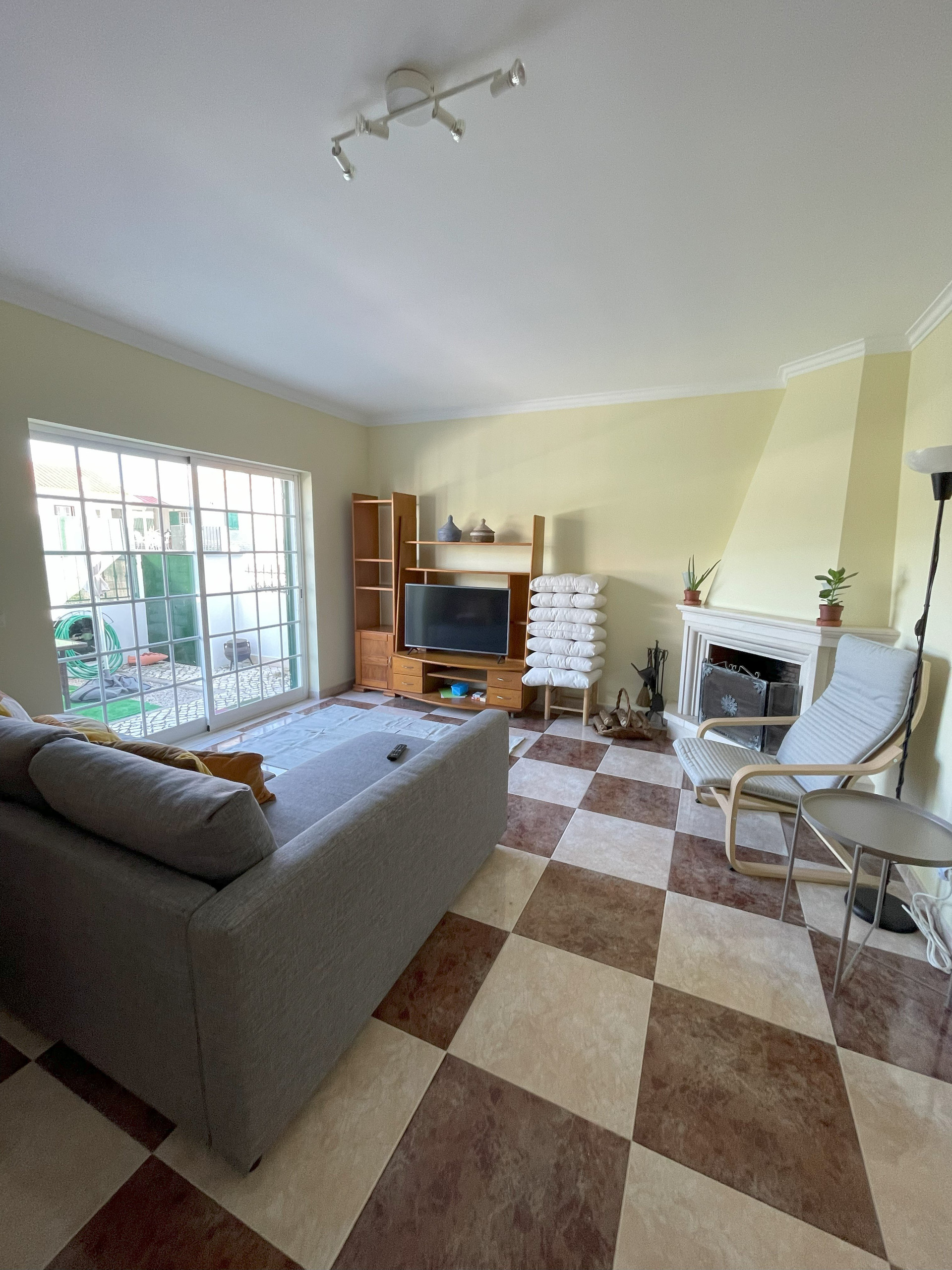 Living room with fireplace and TV