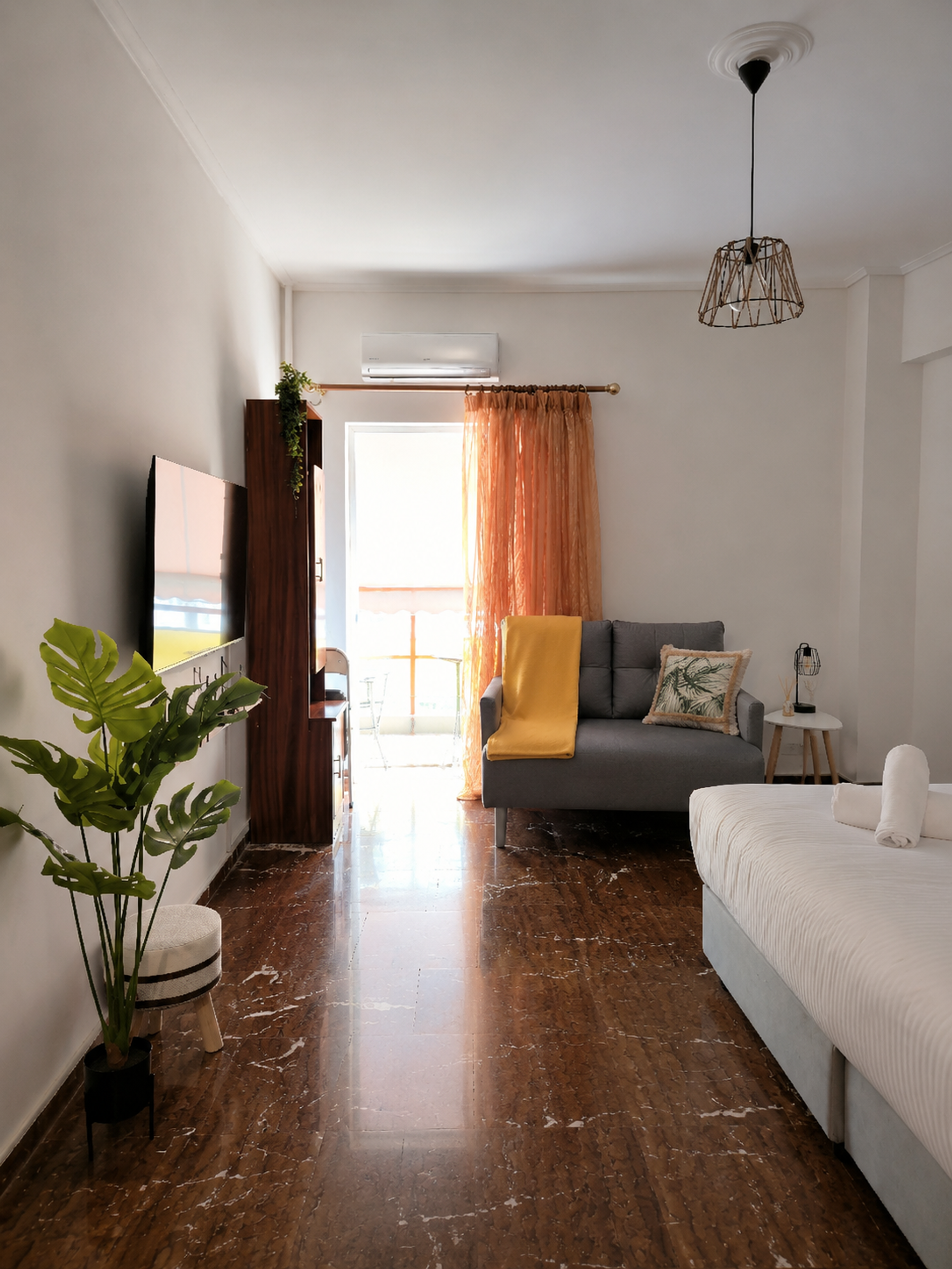 Spacious bedroom with TV and balcony