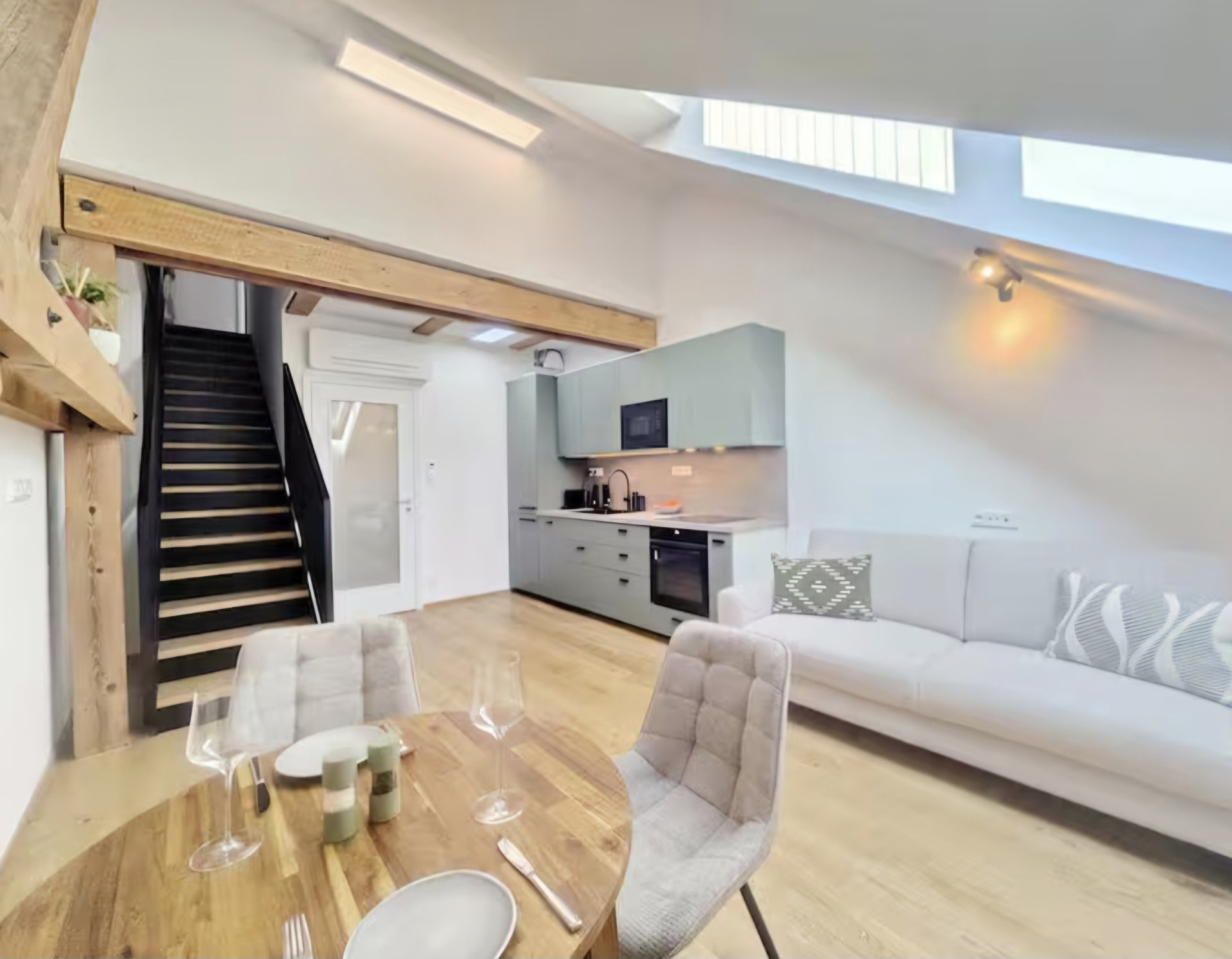 Open kitchen and living area with stairs