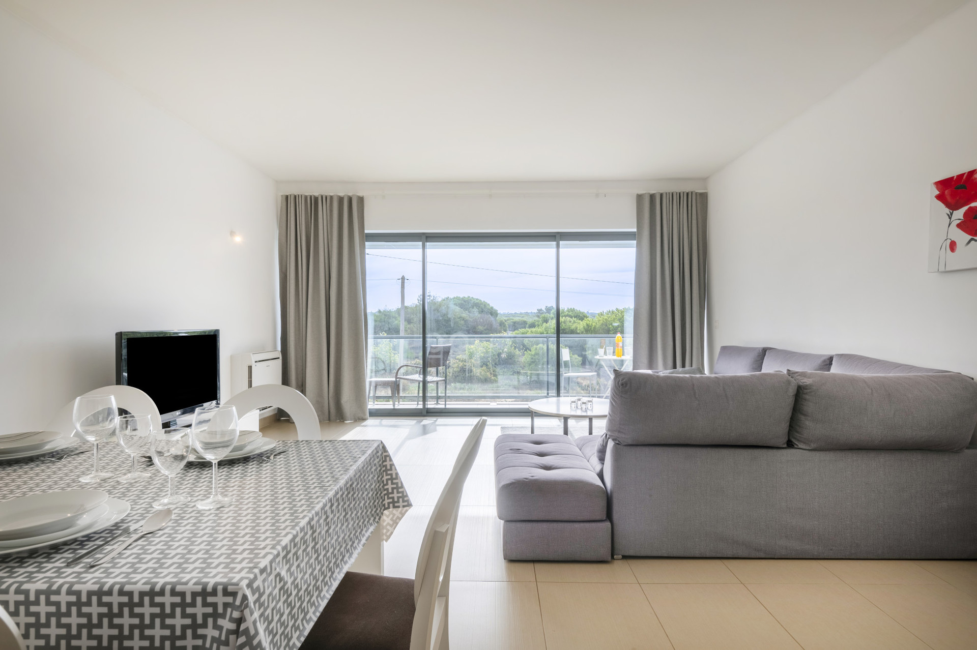 Living Room with a TV, Sofa, AC and Dining Area