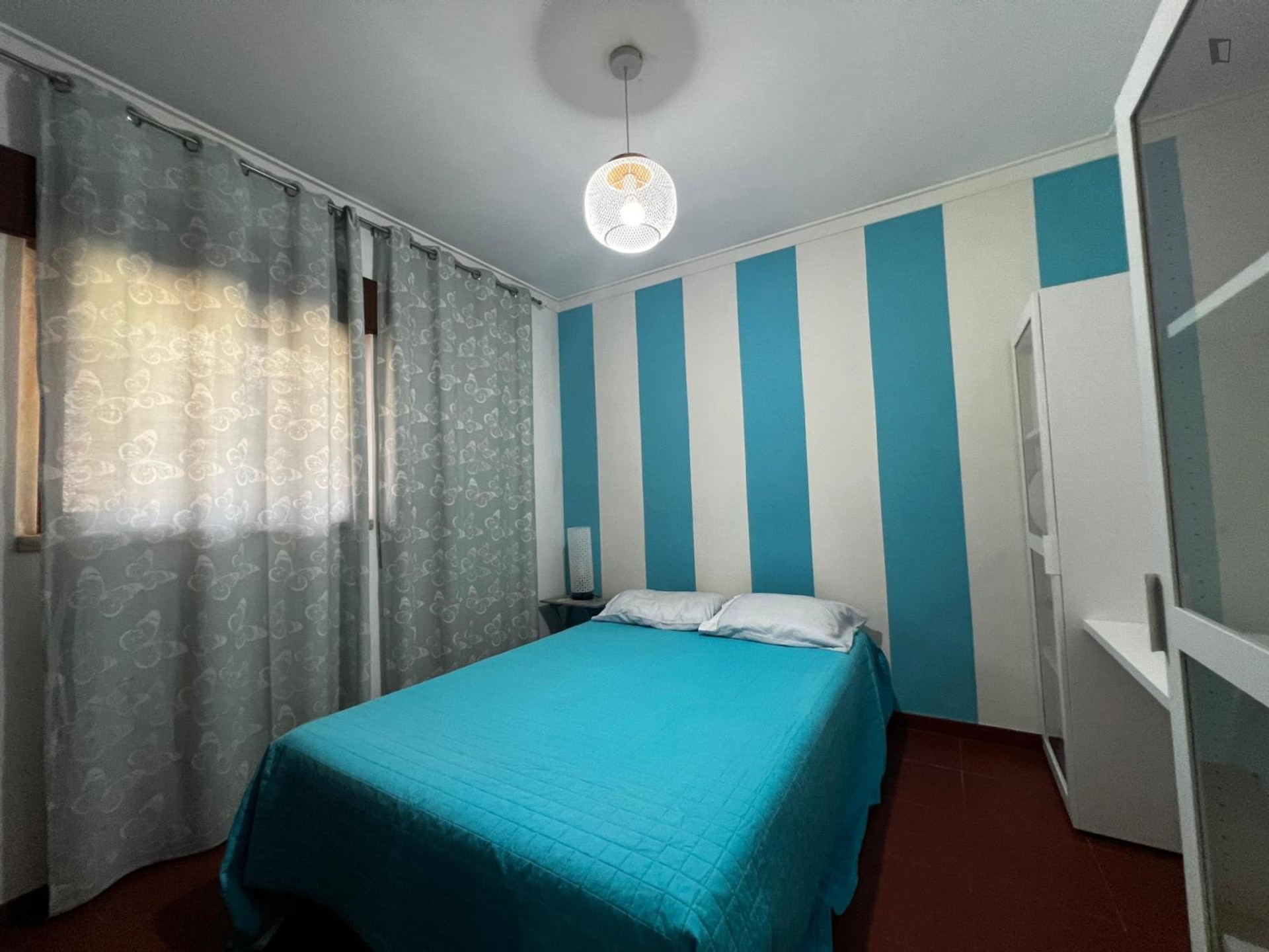 Bedroom with blue striped wall
