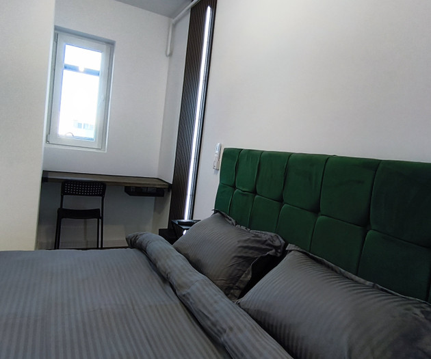 Bedroom with green headboard bed