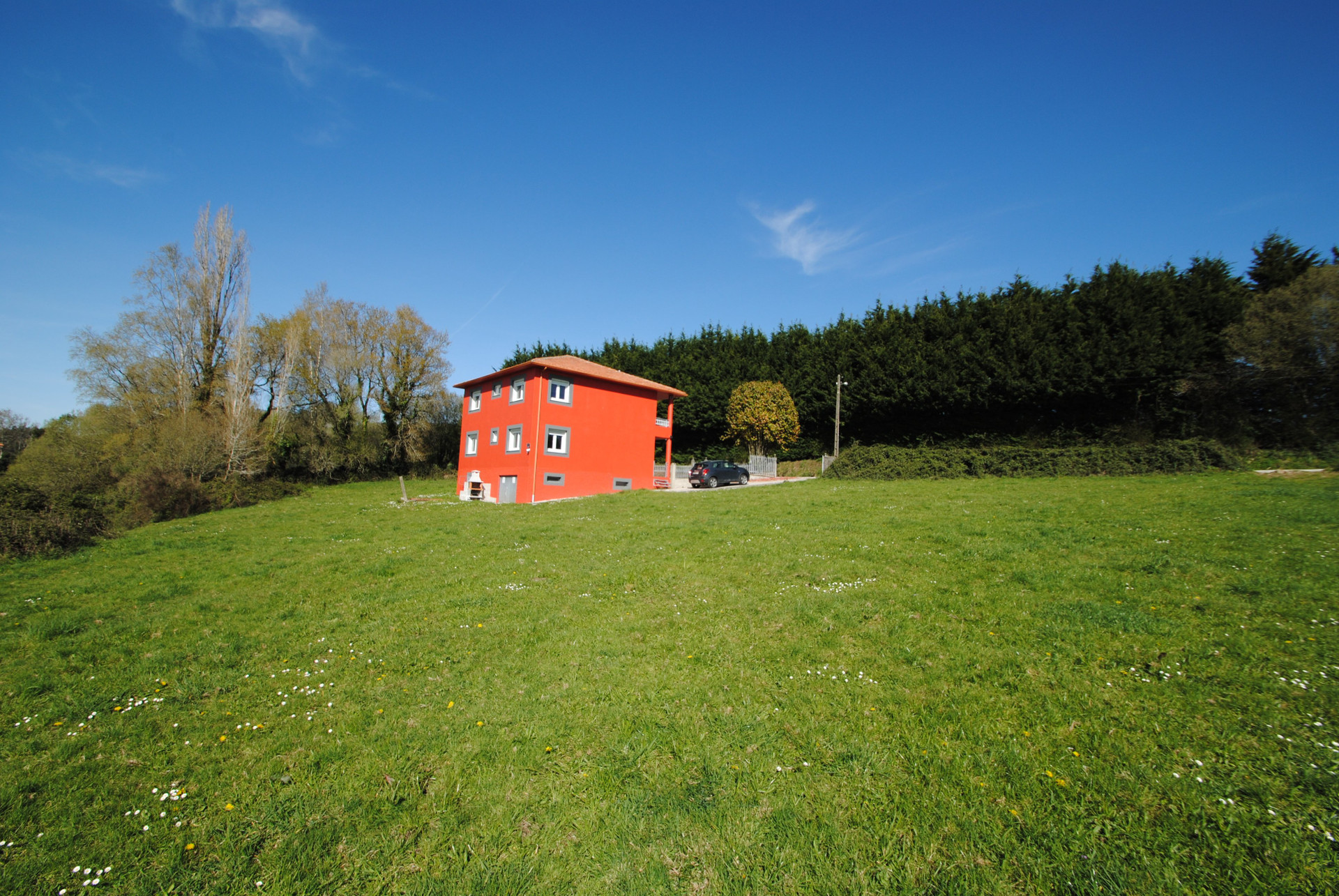 House exterior with green meadow