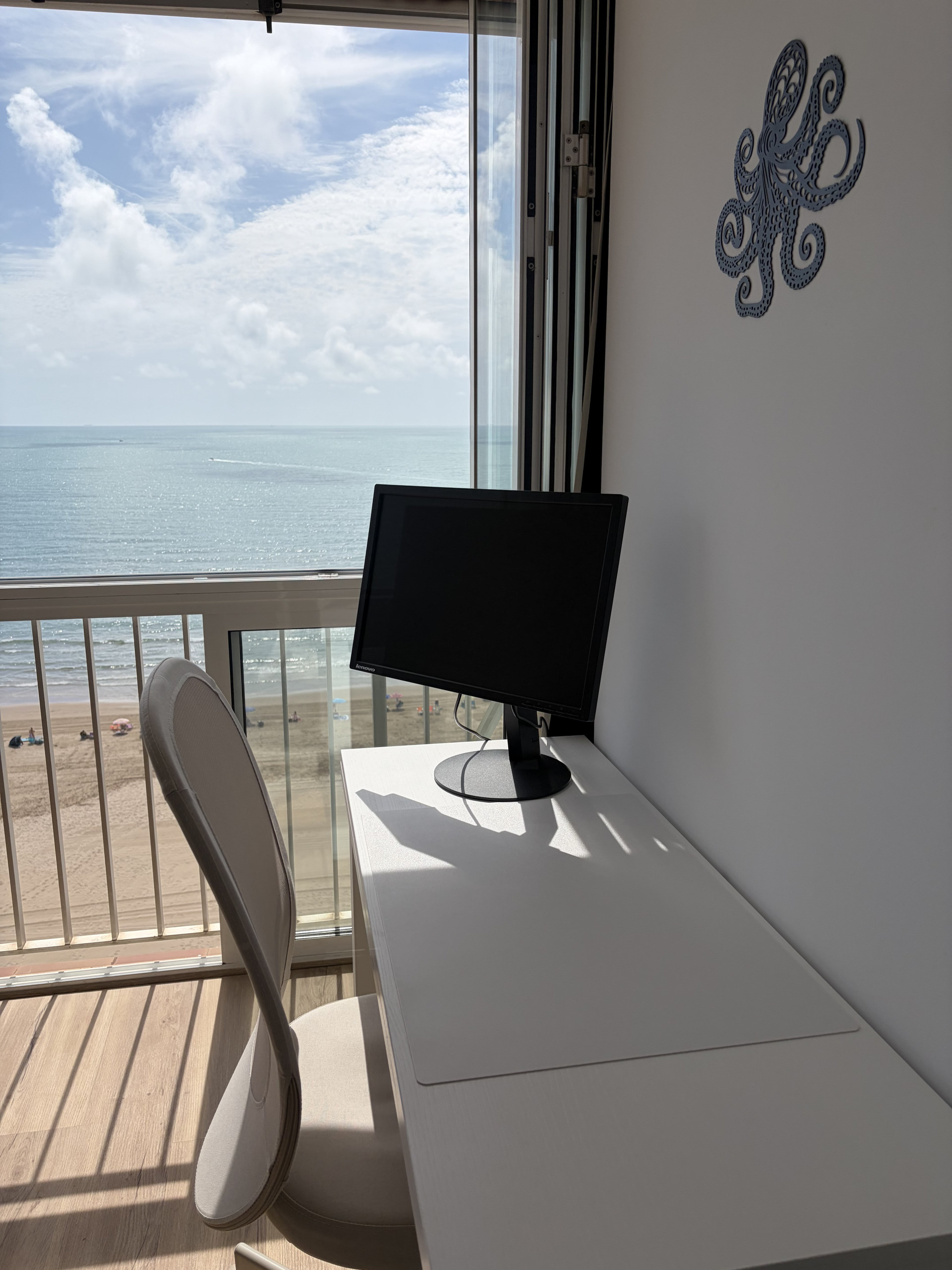 Desk corner with monitor, sea view