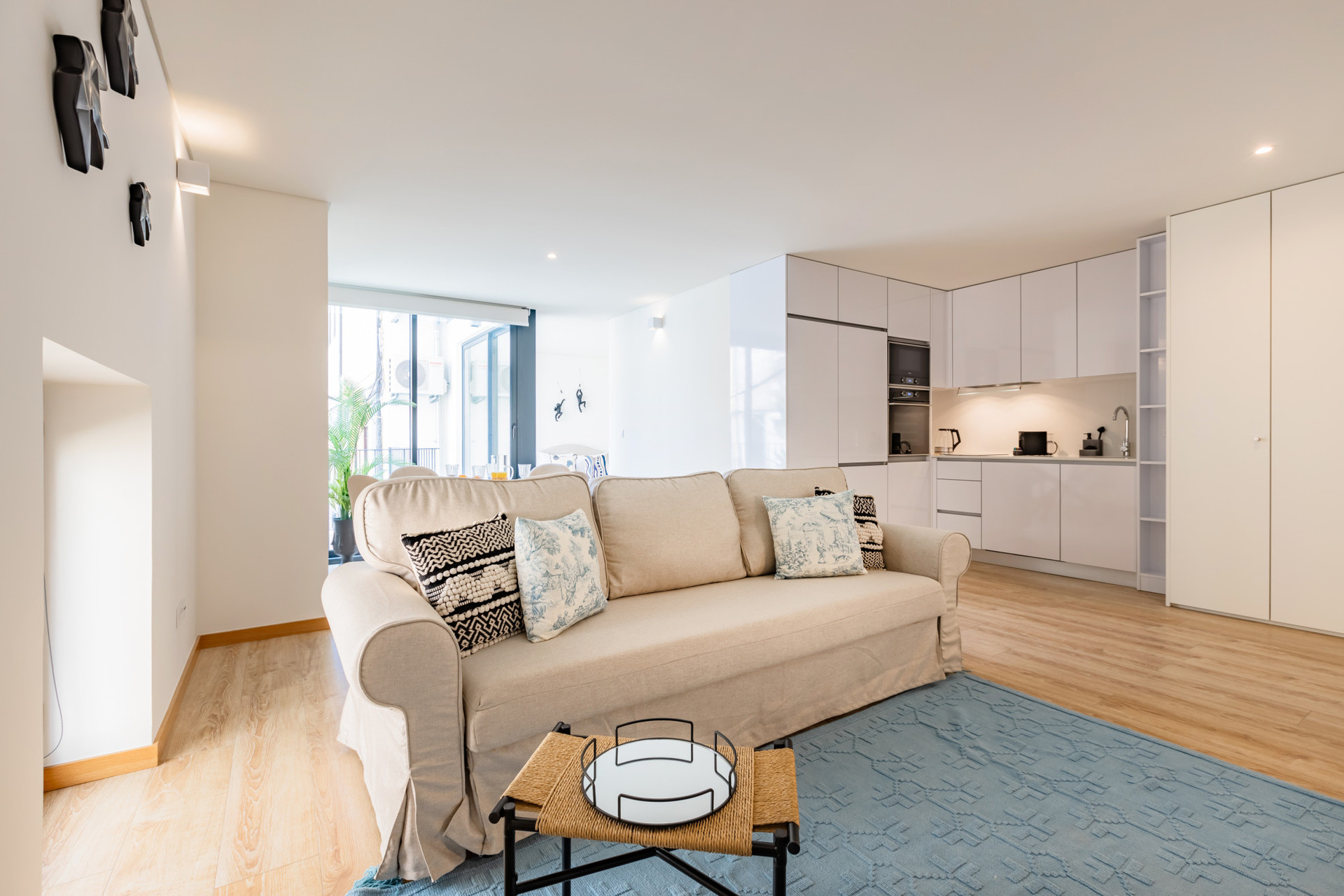 Living area with sofa, TV and AC. Dining table for 4. The full length french windows flood the space with light!