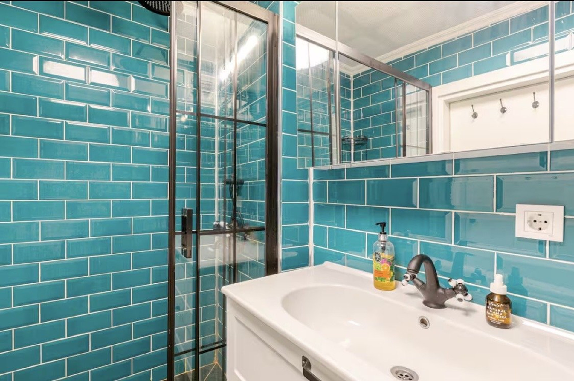 Bathroom with teal tile shower
