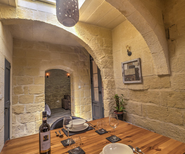 Stone archway dining area with table