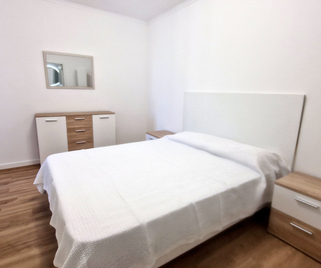 Bedroom with double bed and mirror