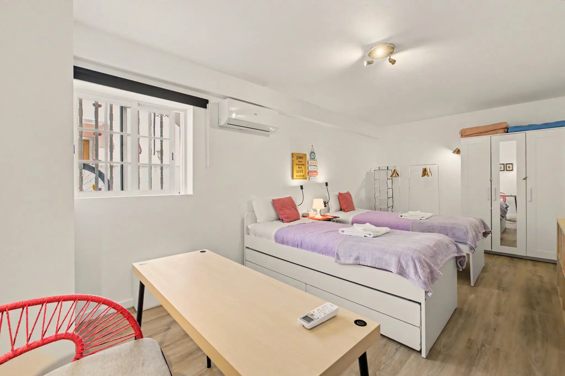 Twin bedroom with desk and wardrobe