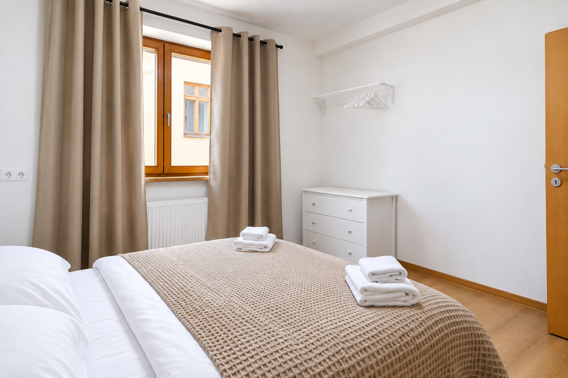 Cozy bedroom with towels and dresser