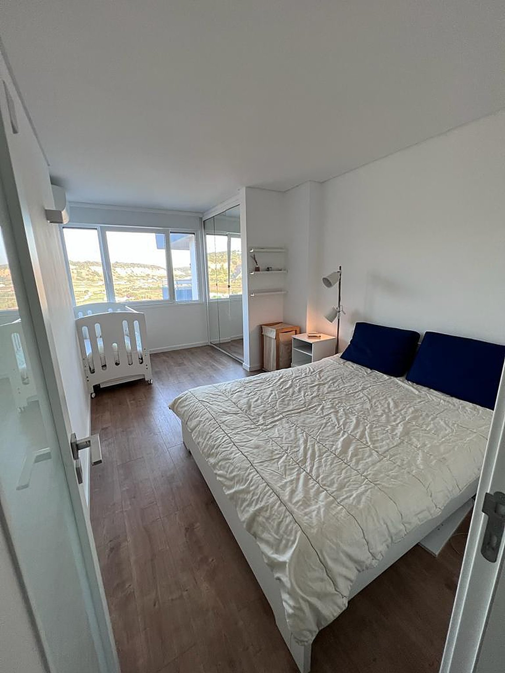 Bedroom with double bed and crib