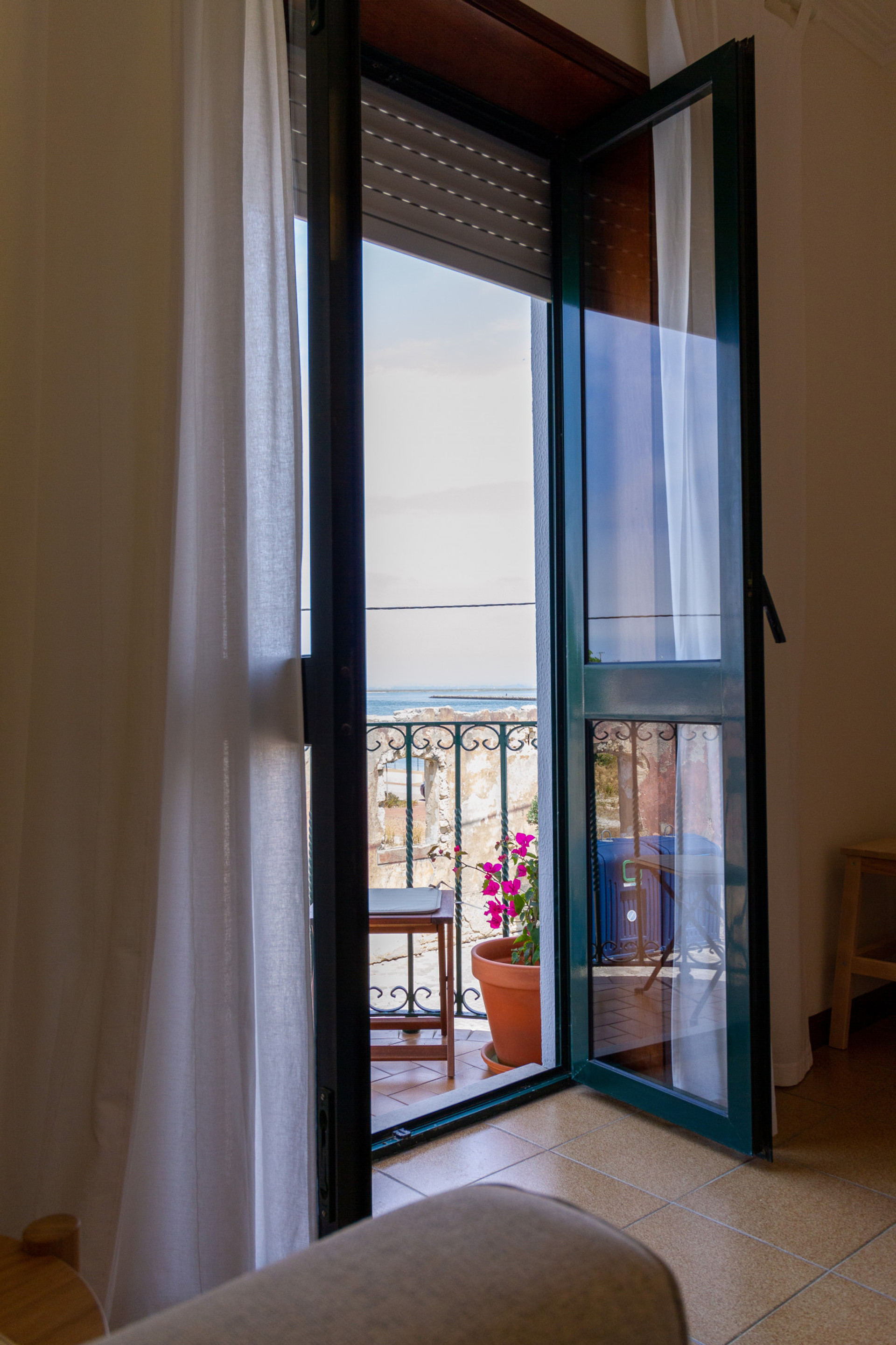 Glimpse through the balcony door in Apartment B of Casa dos Jacintos, São Jacinto, Aveiro - Portugal