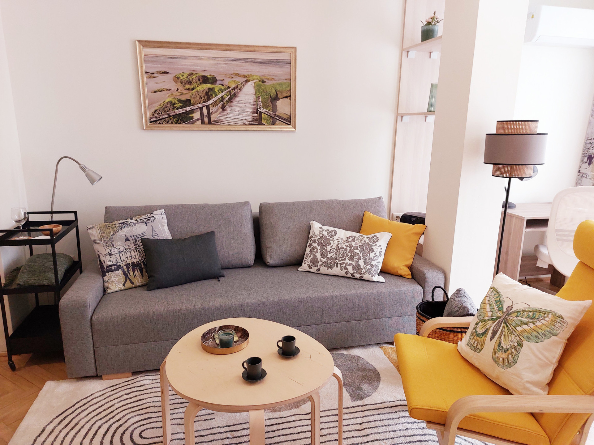 Living room (black movable serving table is next to the sofa))