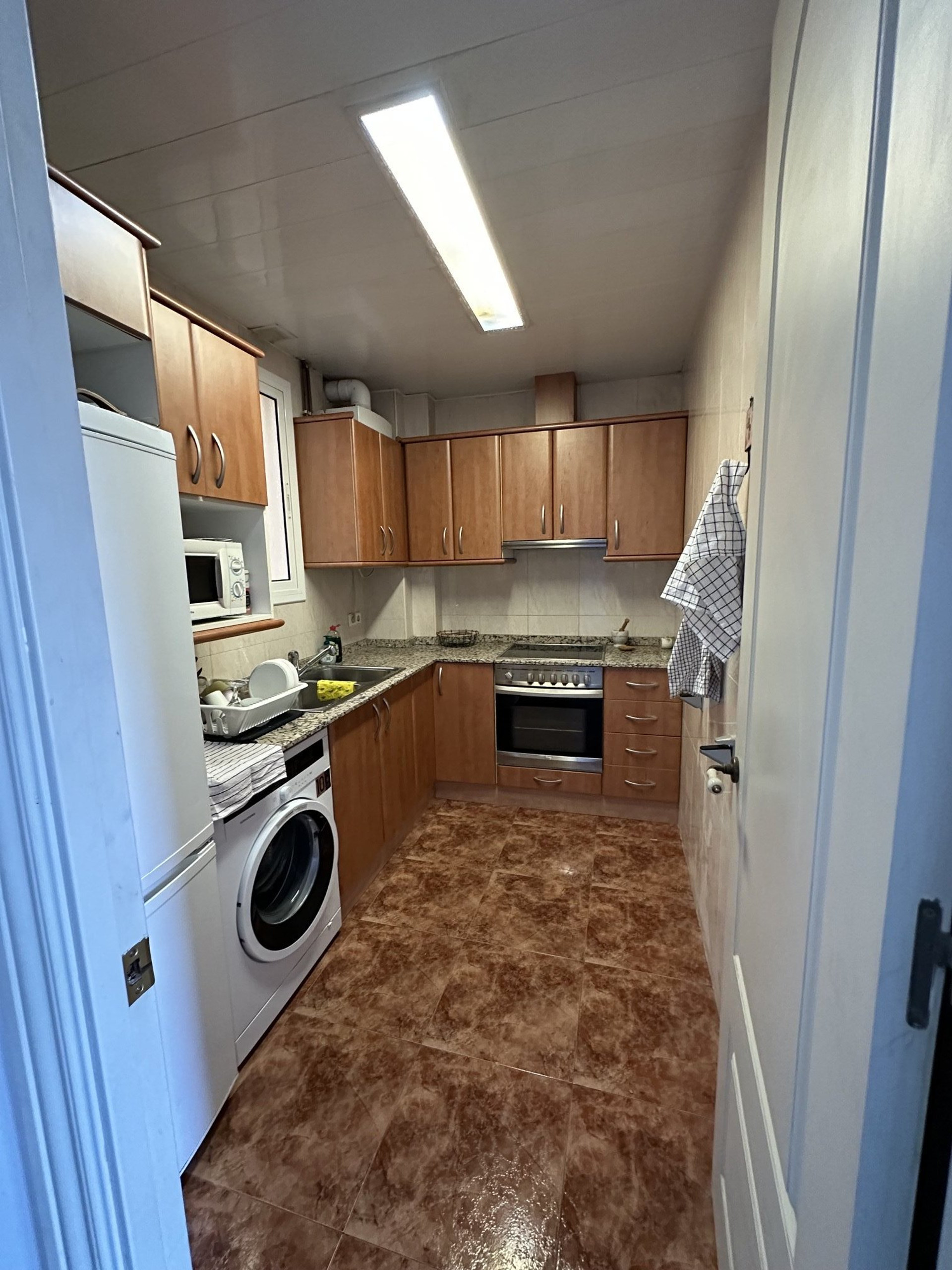 Kitchen with wooden cabinets and appliances