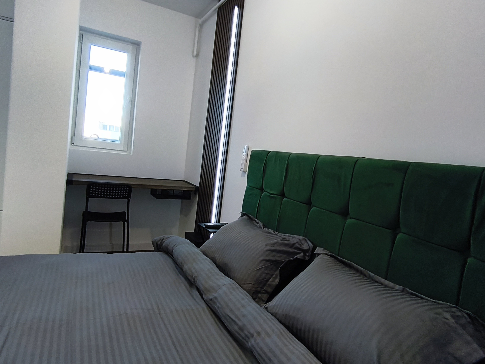 Bedroom with green headboard bed