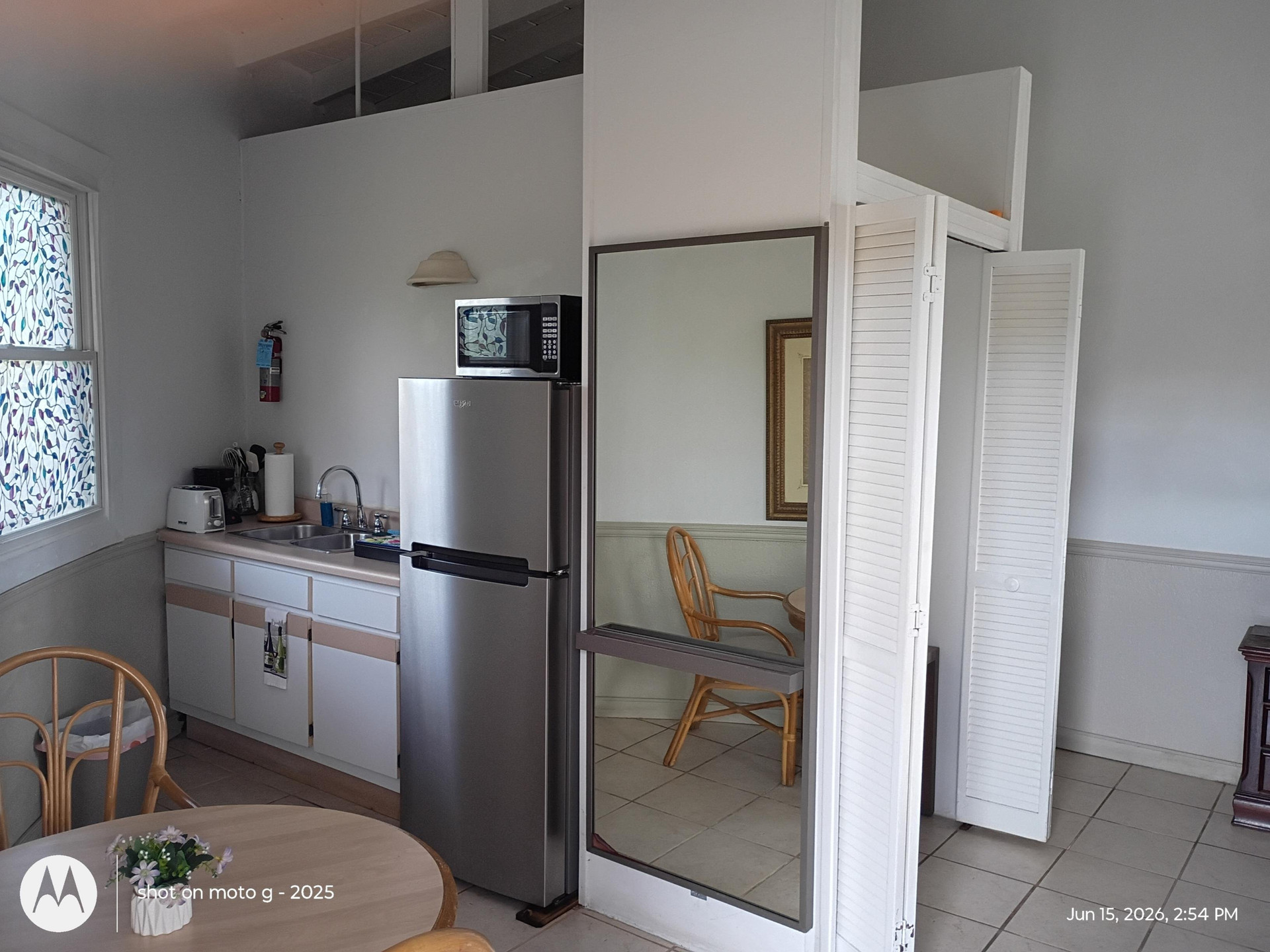 Kitchen with fridge and mirror