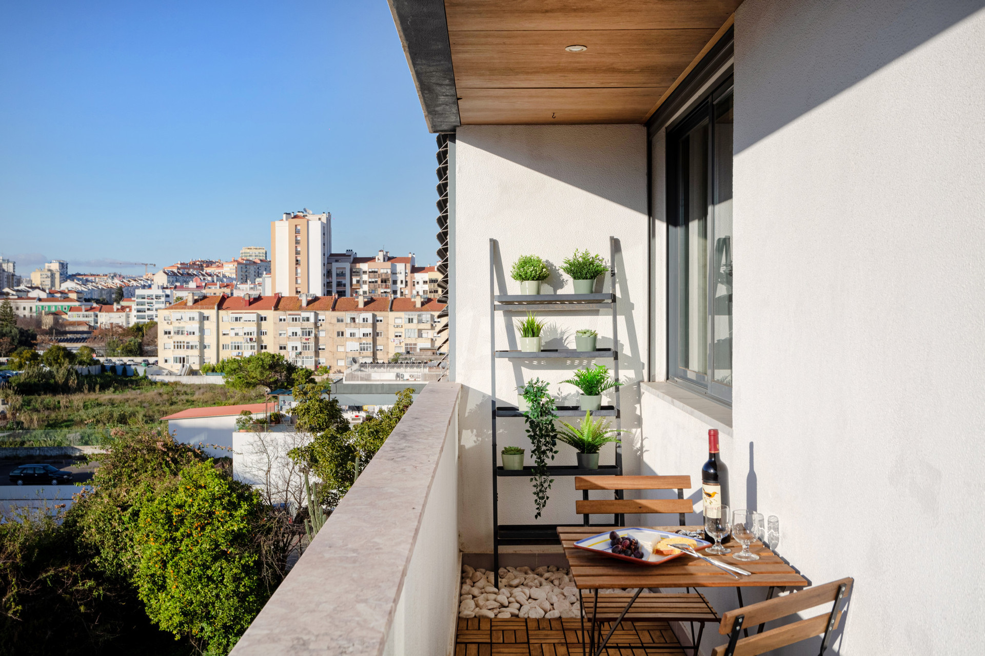 Balcony with a dining table and view over the city. Accessed through the living room