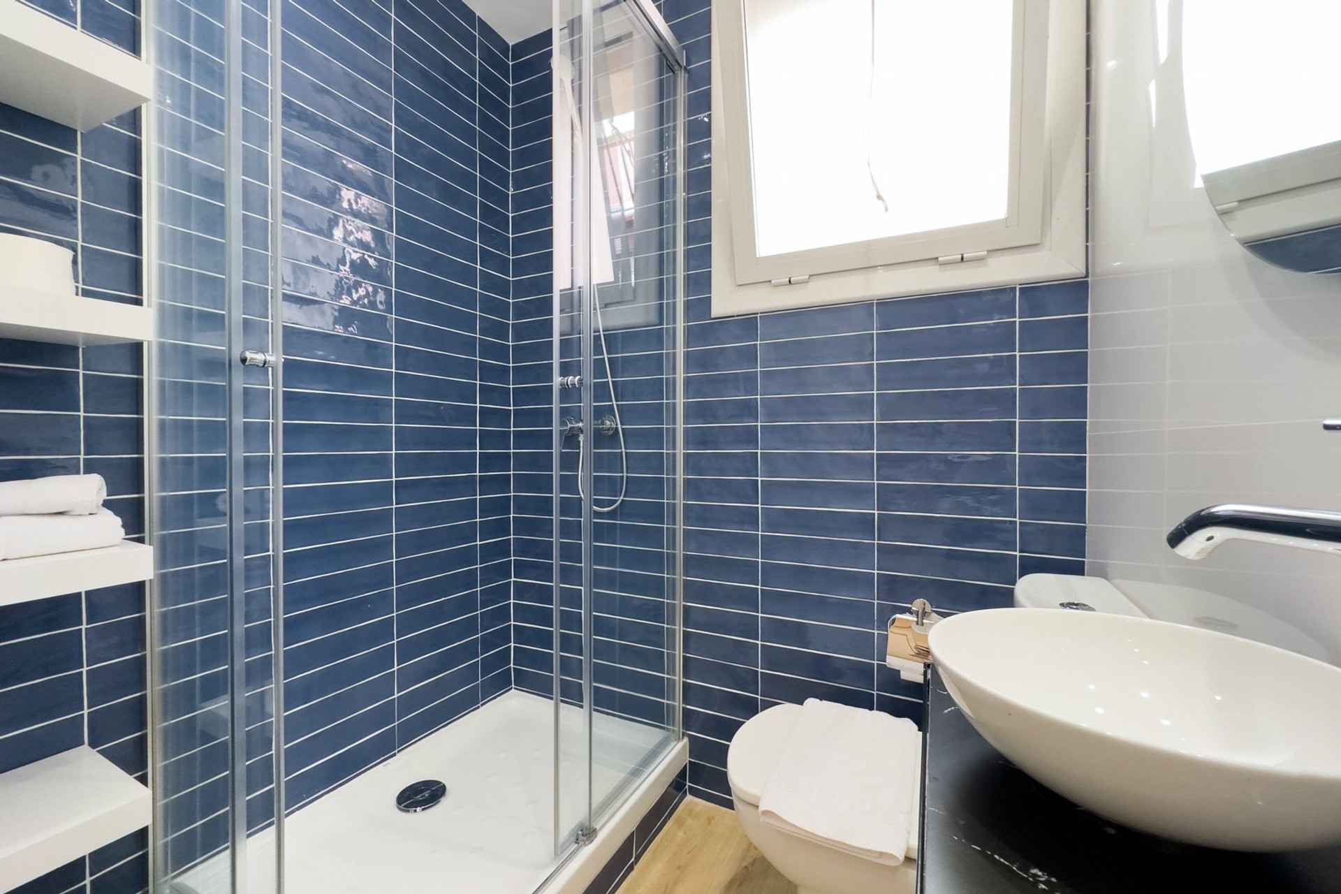 Blue tiled bathroom with shower