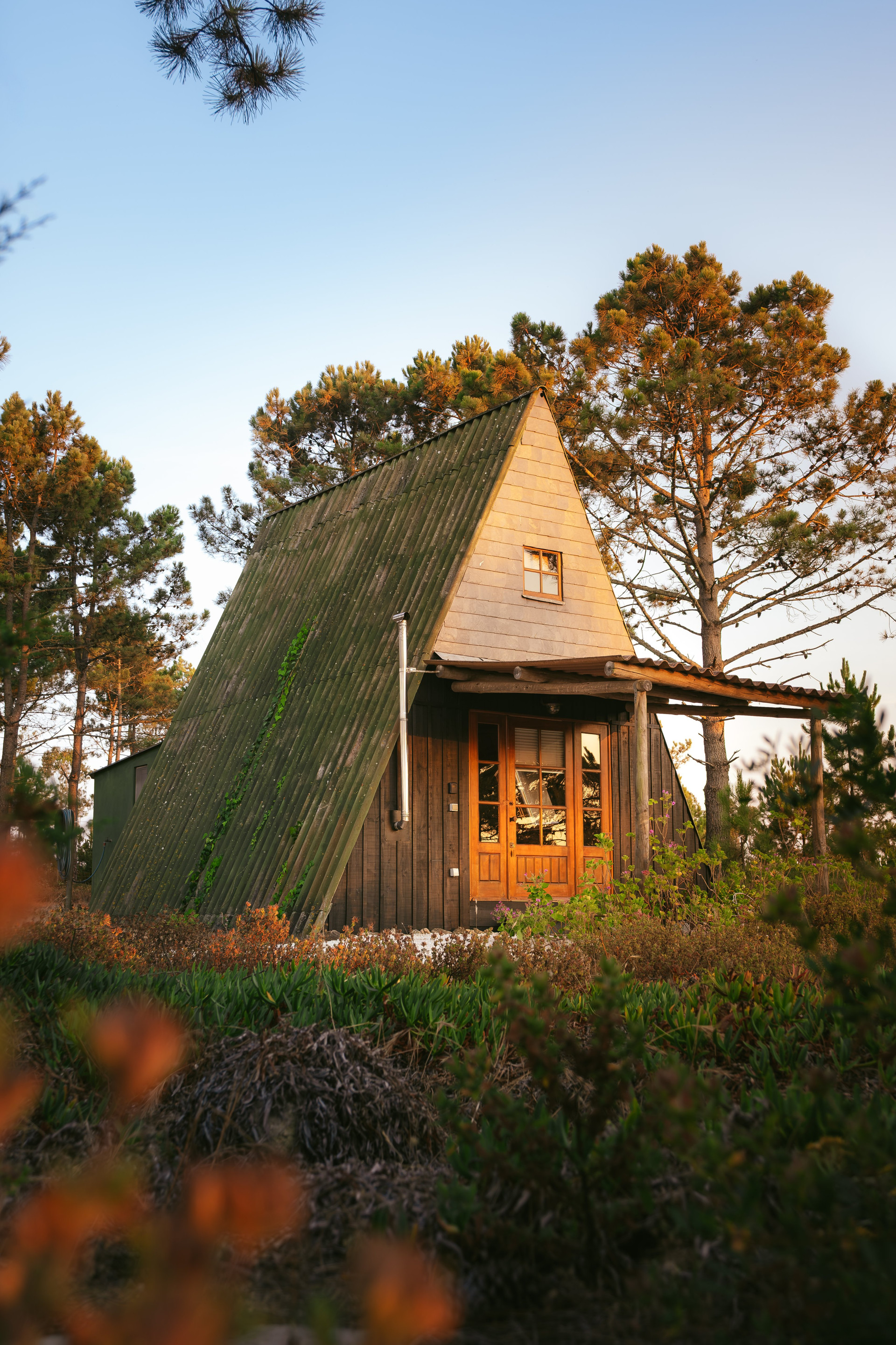 A-frame cabin exterior at sunset