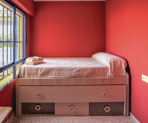 Red bedroom with single bed