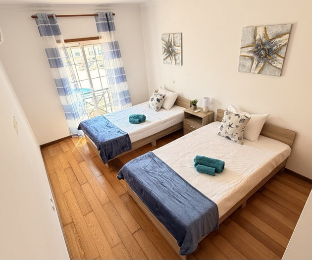 Twin beds with balcony window
