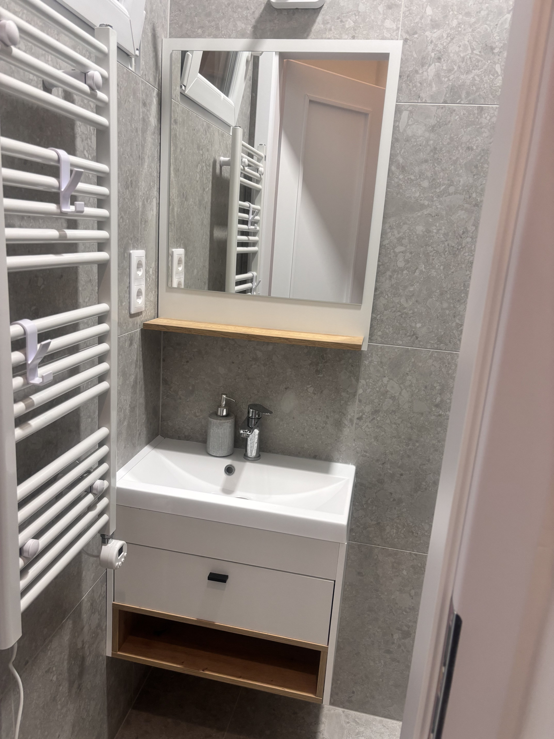 Bathroom vanity with heated towel rail