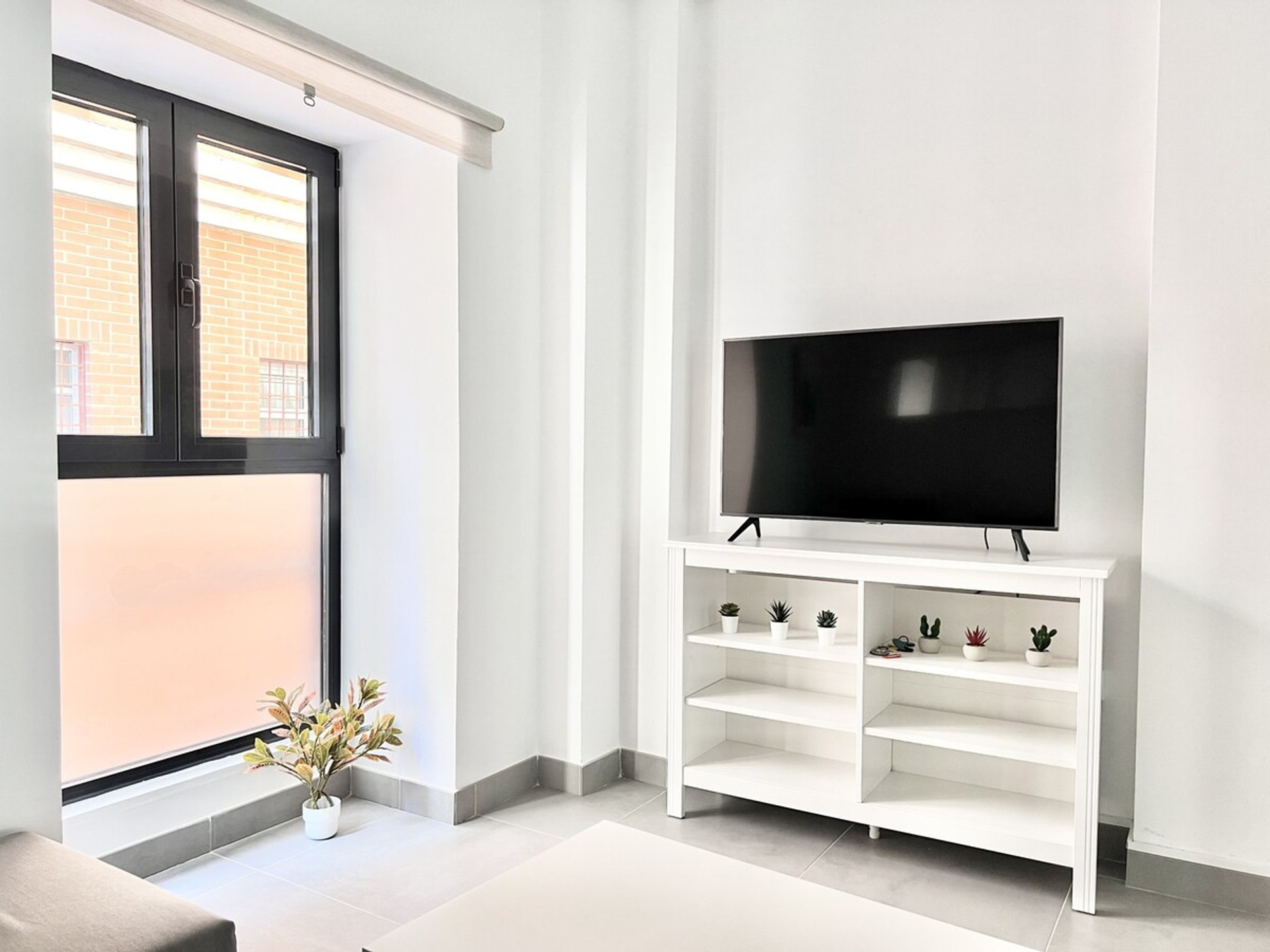 tV area with window to narrow street