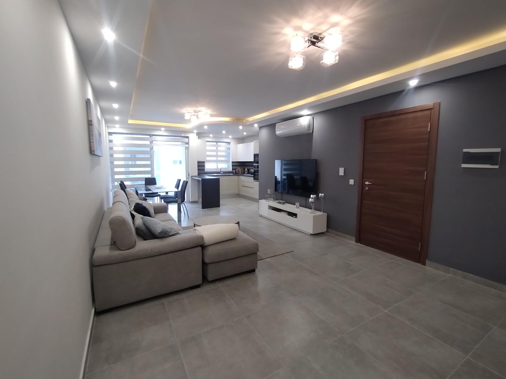 Spacious living room with TV kitchen