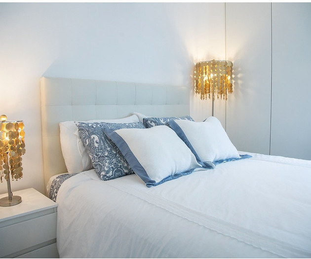 Bedroom nightstands with gold lamps