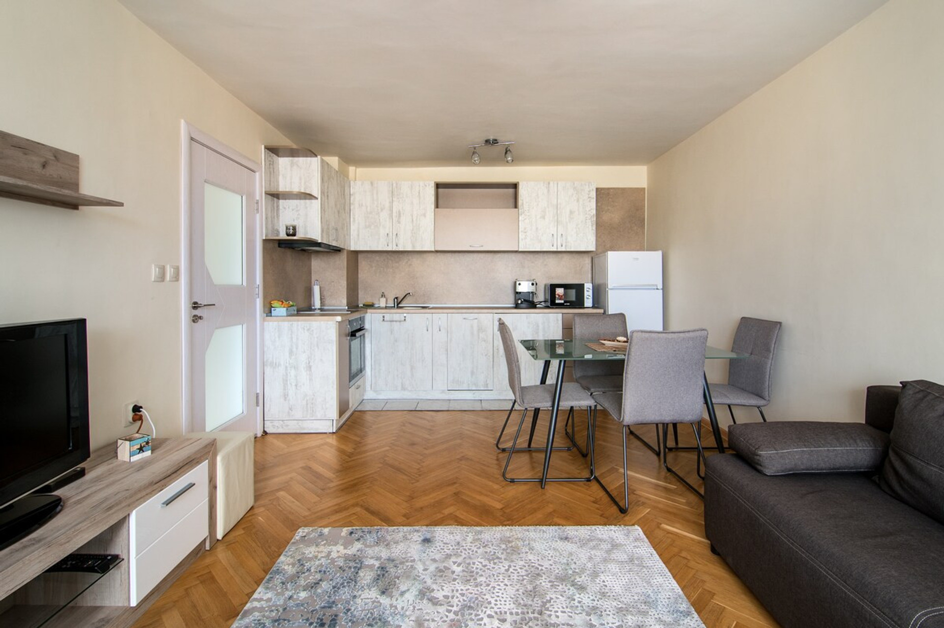 Modern open-plan kitchen & dining area – Fully equipped with sleek cabinetry, a dining table, and all essentials for home-cooked meals. A great space for guests who love to cook and dine in comfort.