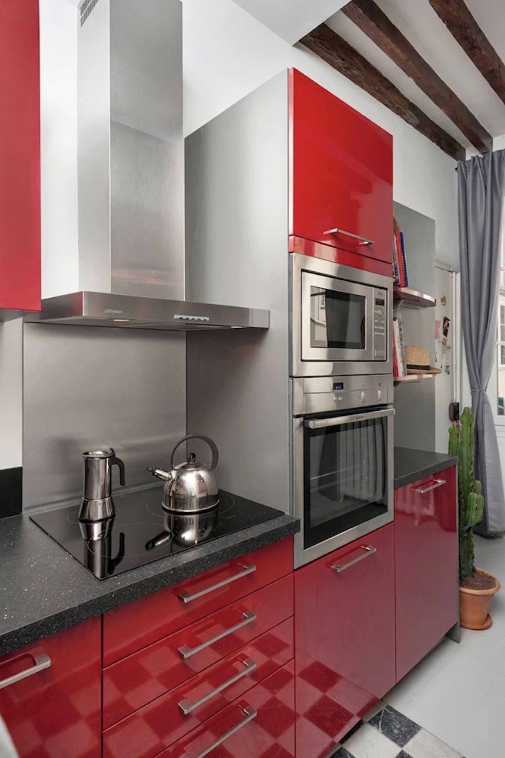 Fully-equipped kitchen with a stylish coffee station and abundant character from exposed ceiling beams.