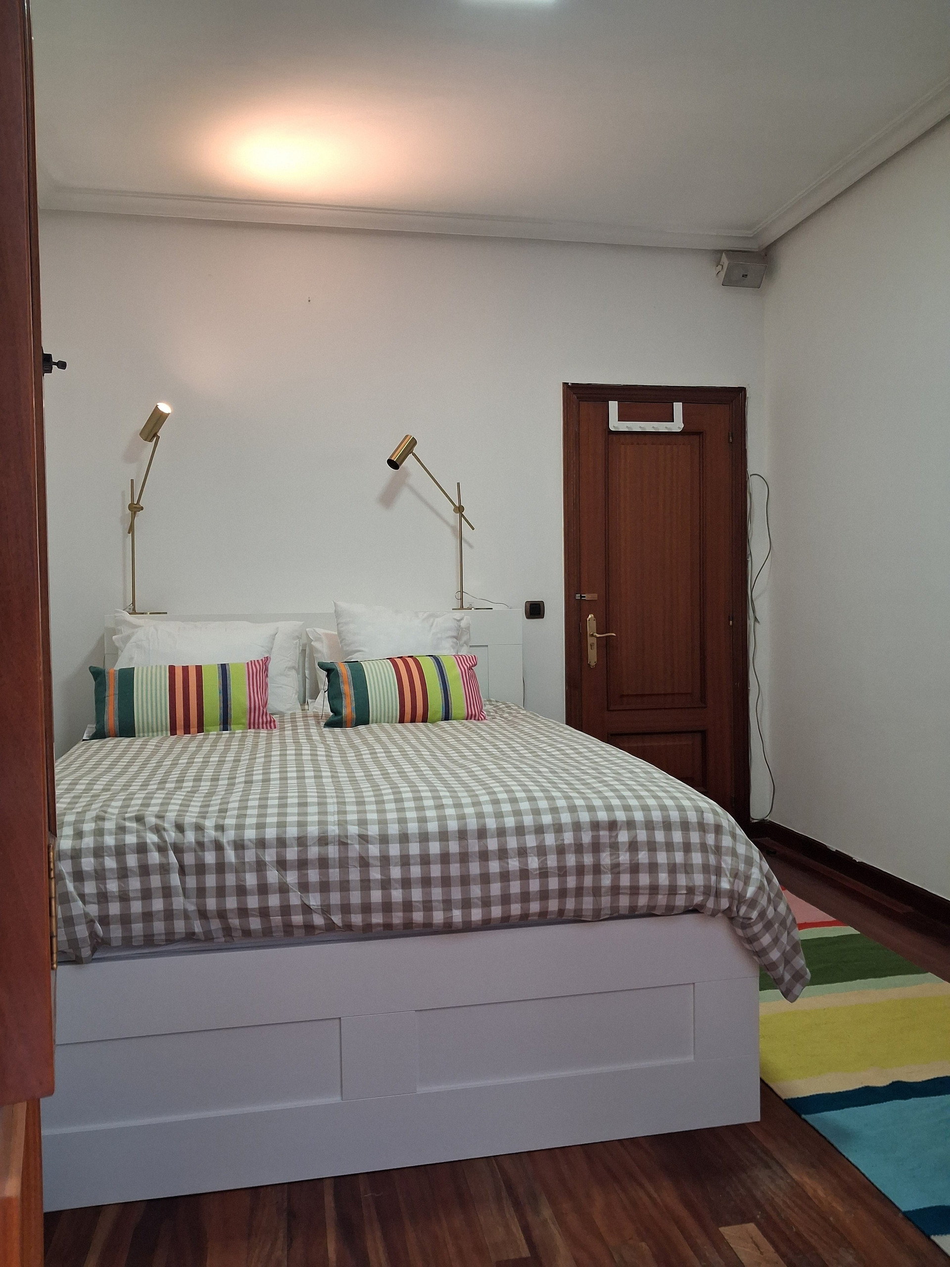 Bedroom with striped rug