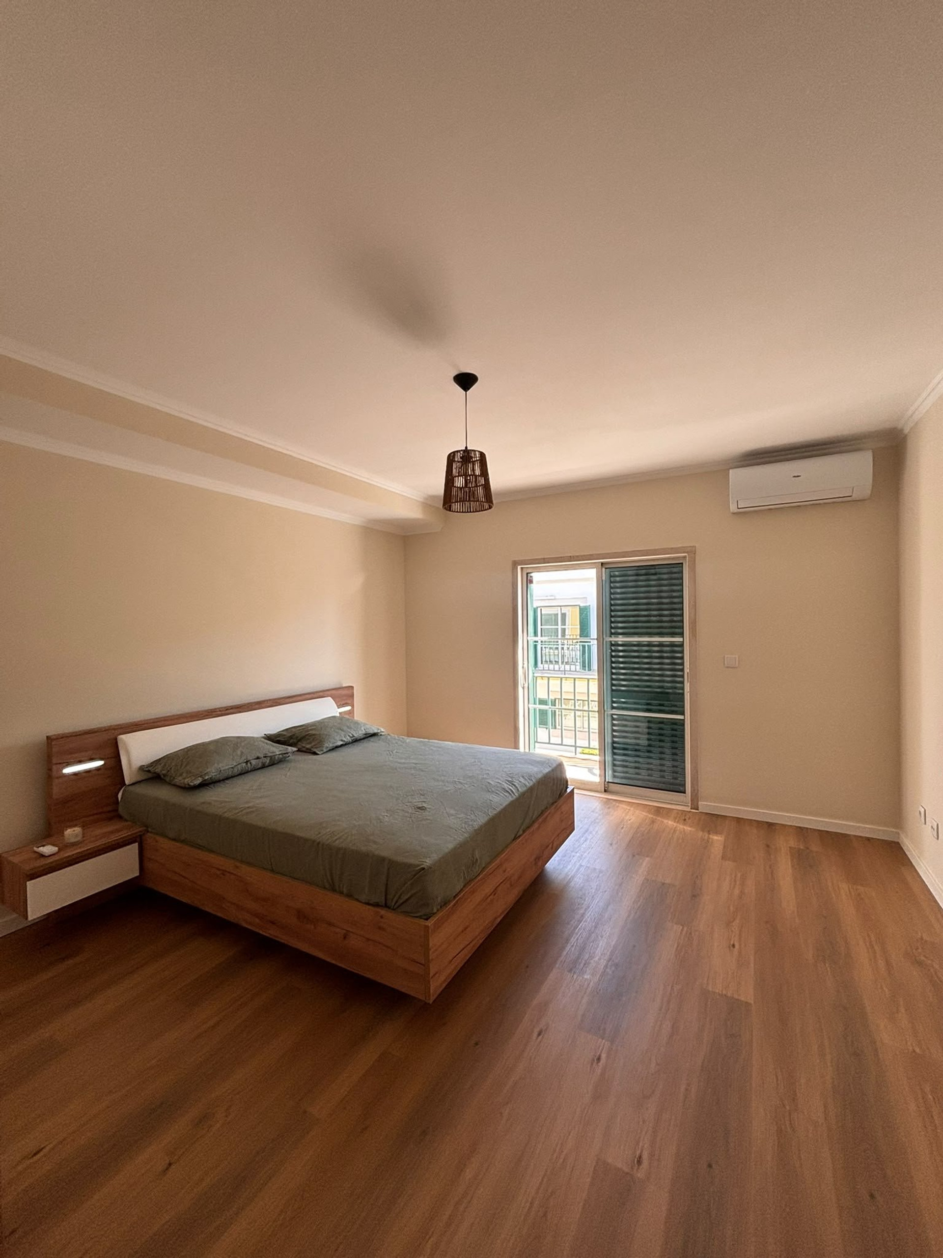 Spacious bedroom with balcony door
