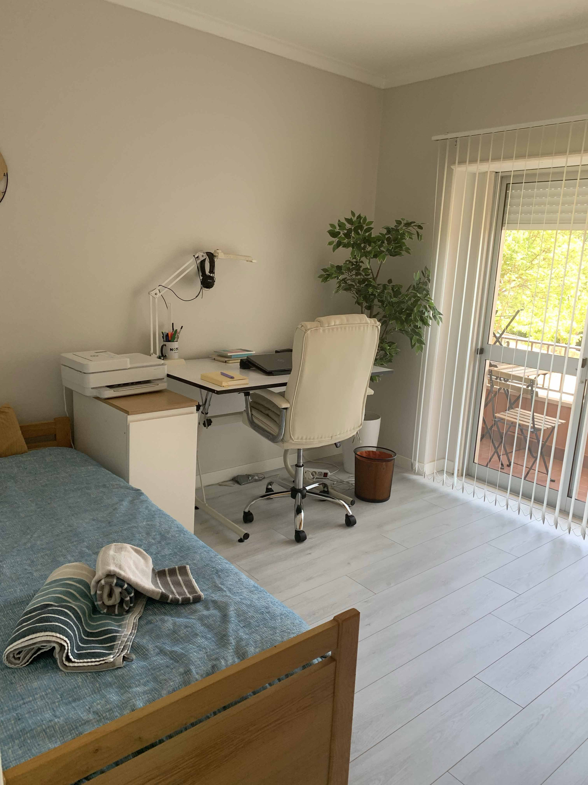 Bedroom with desk and balcony access