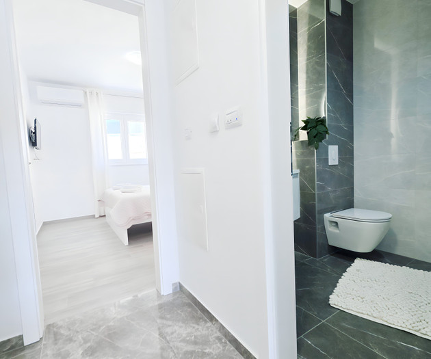 Hallway leading to bedroom and bathroom