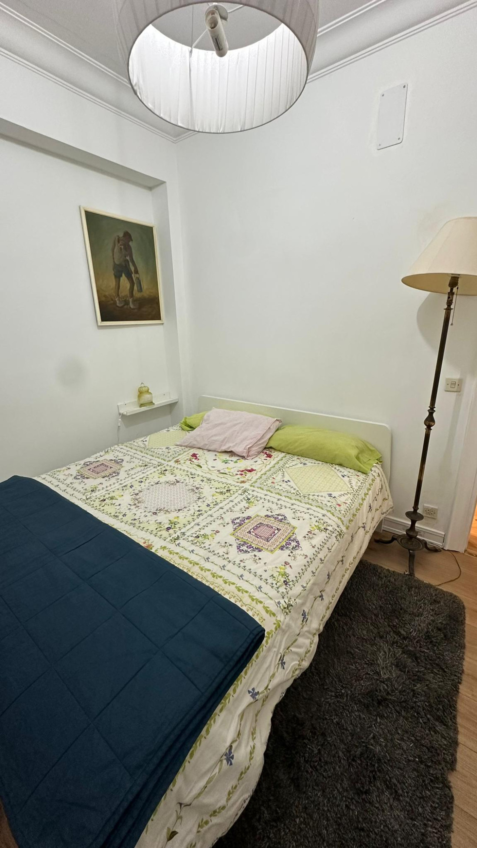 Bedroom with double bed floor lamp
