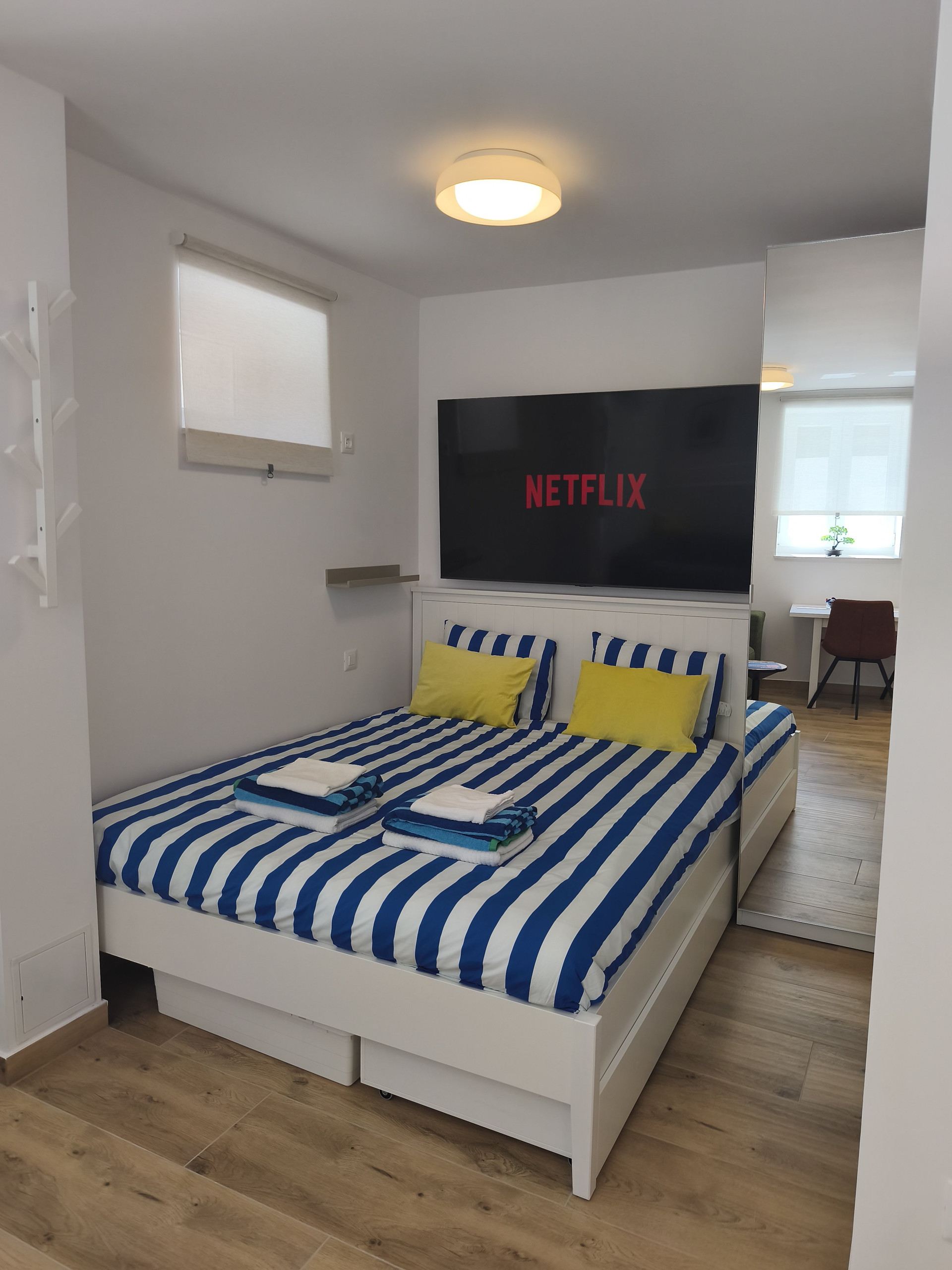 Bedroom with Netflix TV and living view