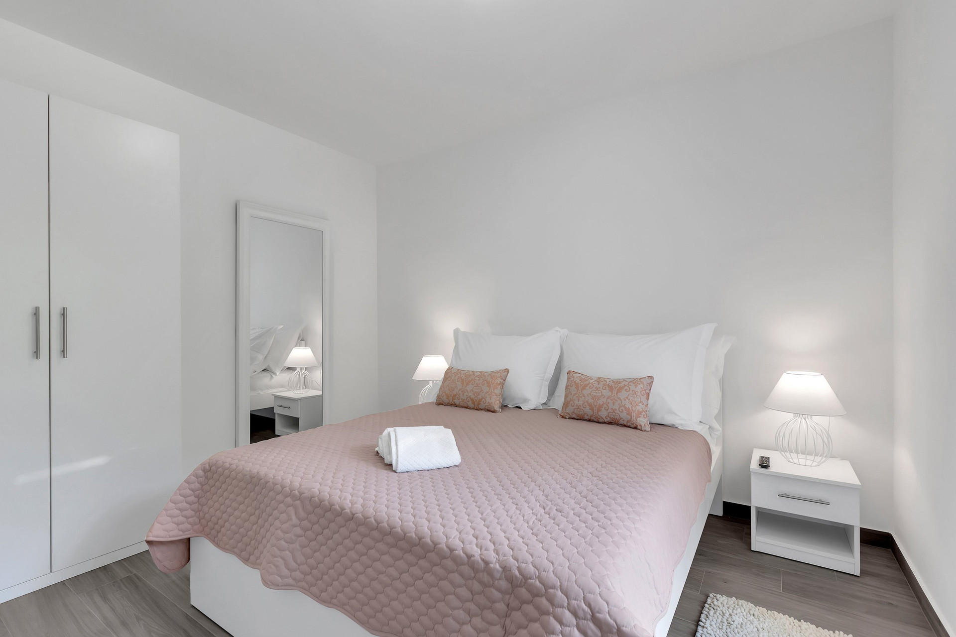 Bright bedroom with pink bedspread