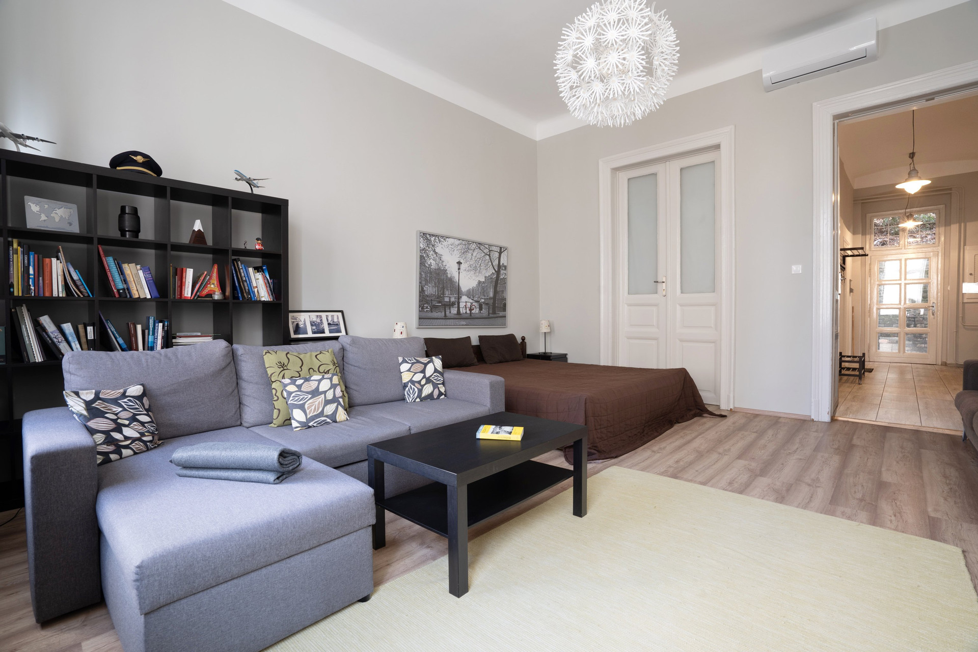 Living room with sectional and bed