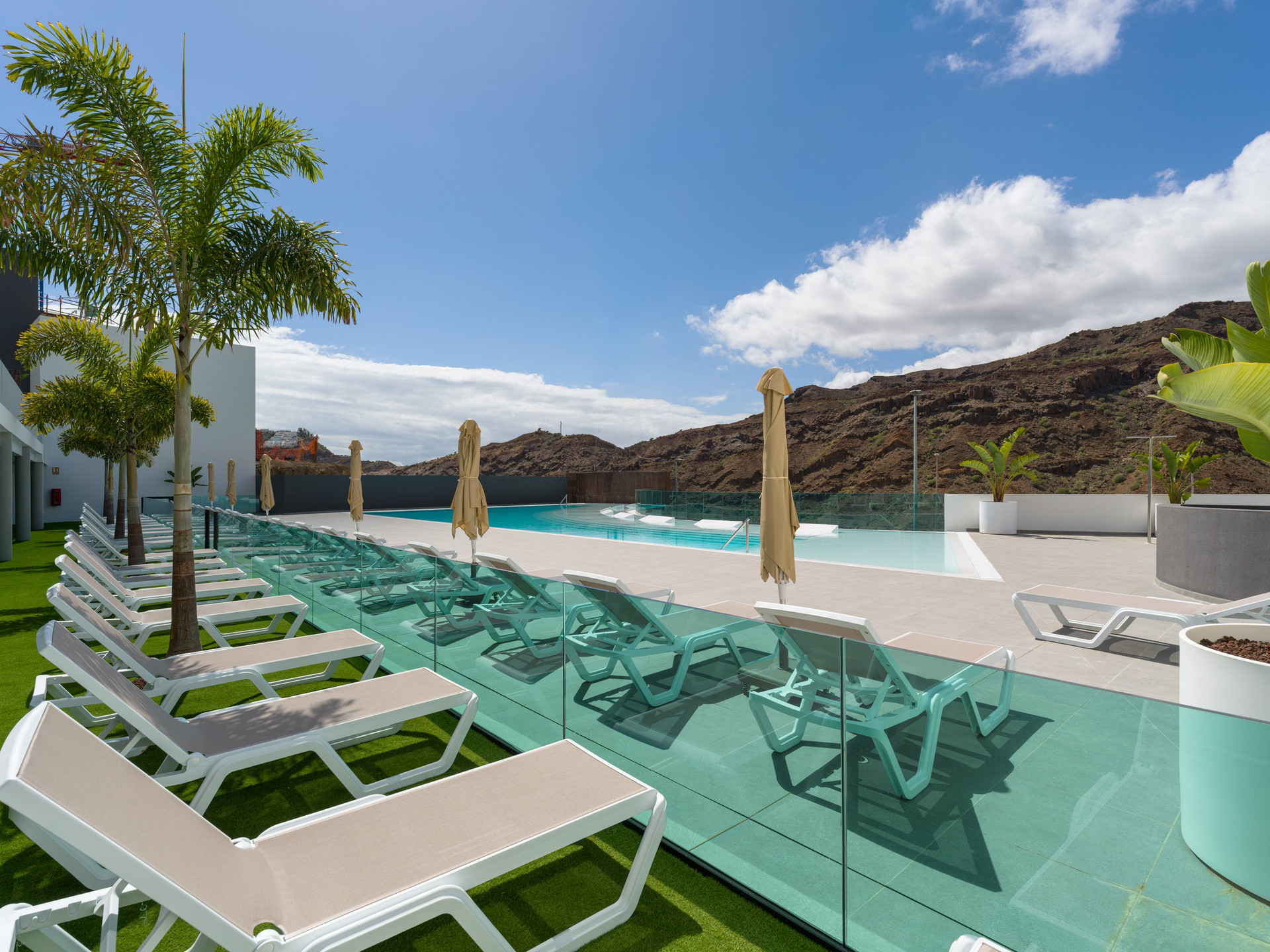 Outdoor pool terrace with loungers