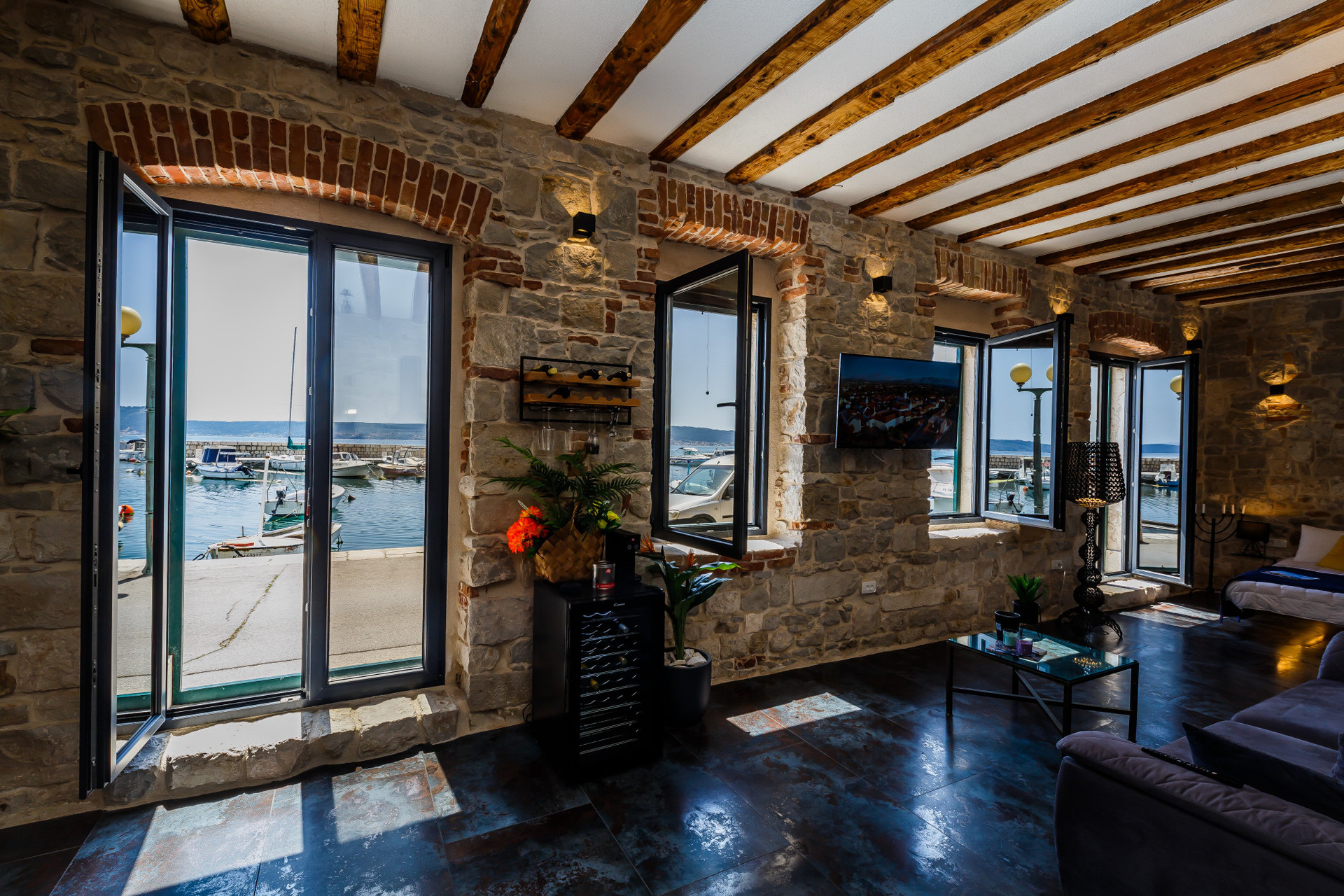Living room stone walls harbor views