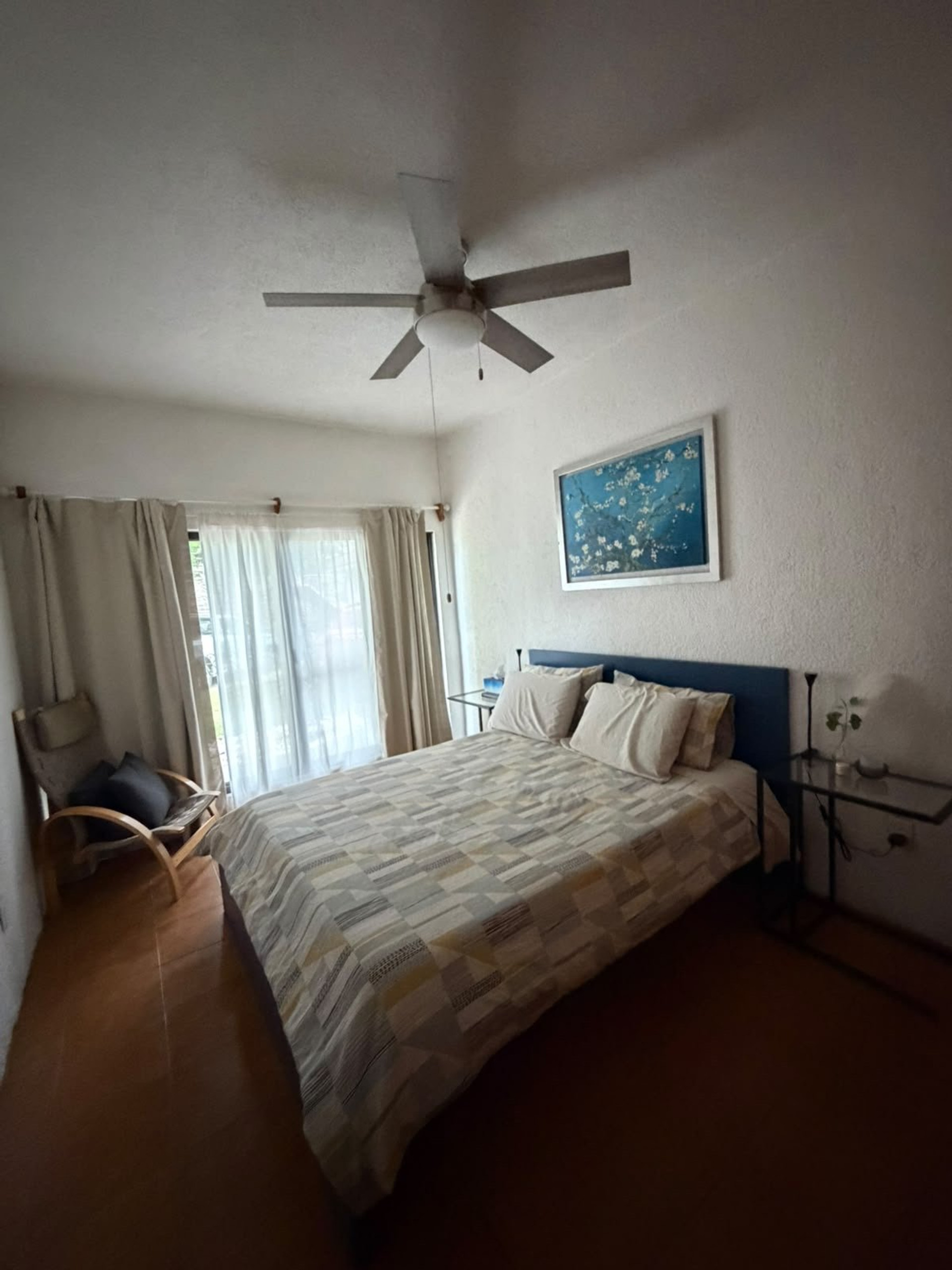 Bedroom with queen bed and window