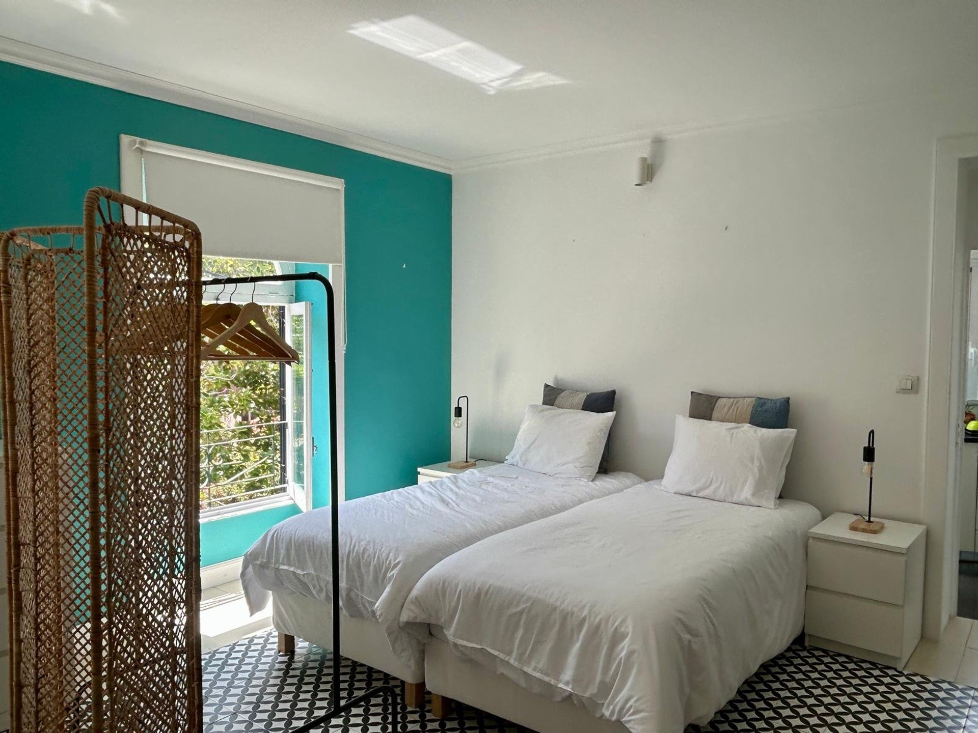 Bedroom with twin beds, teal wall