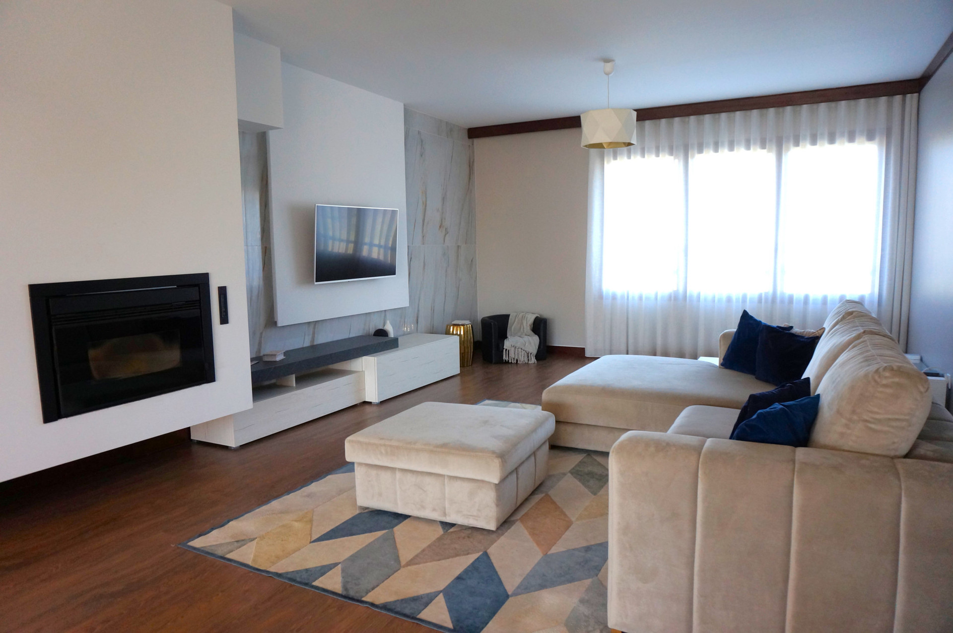 Living room with fireplace and TV