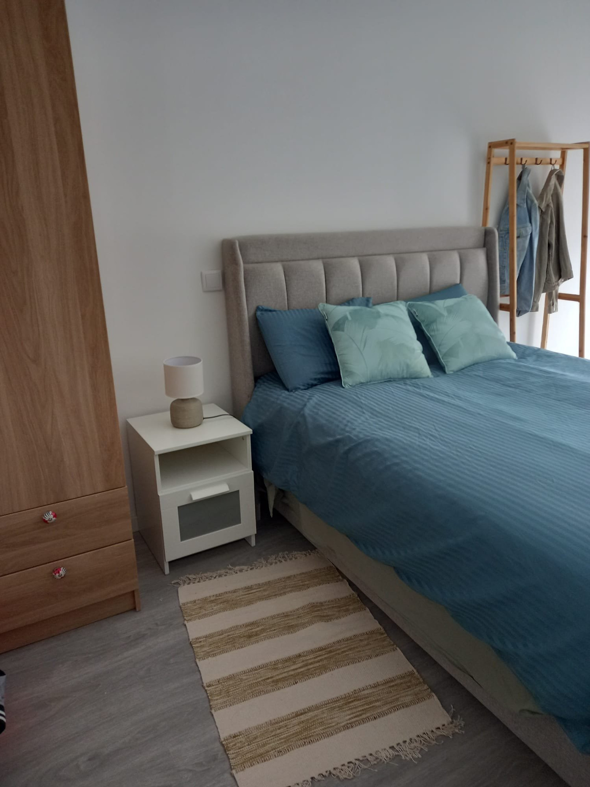 Bedroom with blue bedding and wardrobe
